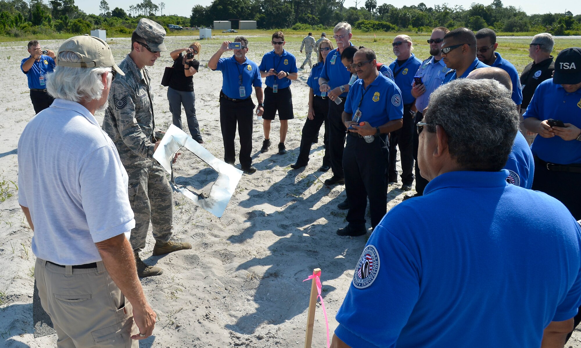 Members of the 6th Civil Engineer Squadron (CES) and Transportation Security Administration (TSA) view various improvised explosive device (IED) detonation sites at MacDill Air Force Base, Fla., June 1, 2016. The 6th CES partnered with TSA to demonstrate the various explosive capabilities and impacts of IEDs. (U.S. Air Force photo by Staff Sgt. Shandresha Mitchell)
