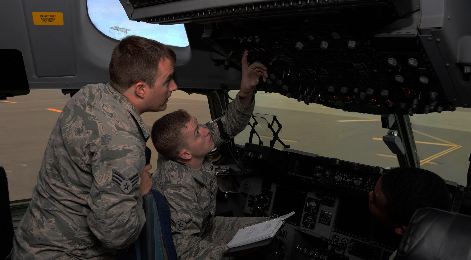 Senior Airman Anthony Boone (Back Left), 860th Aircraft Maintenance Squadron C-17 Globemaster III crew chief, explains the refueling process to Airman Rudy Katz (Front Left), 860th AMXS communications and navigations systems specialist, while Senior Airman Khalil Hart (Right), 860th AMXS C-17 crew chief looks on at Travis Air Force Base, Calif., June 15, 2016. Crew chiefs oversee the refueling process during pre-flight inspections to ensure the aircraft maintains proper balance. The Airmen of the 860th AMXS maintain more than a dozen C-17's valued at $2.9 billion. (U.S. Air Force photo by Tech. Sgt. James Hodgman)