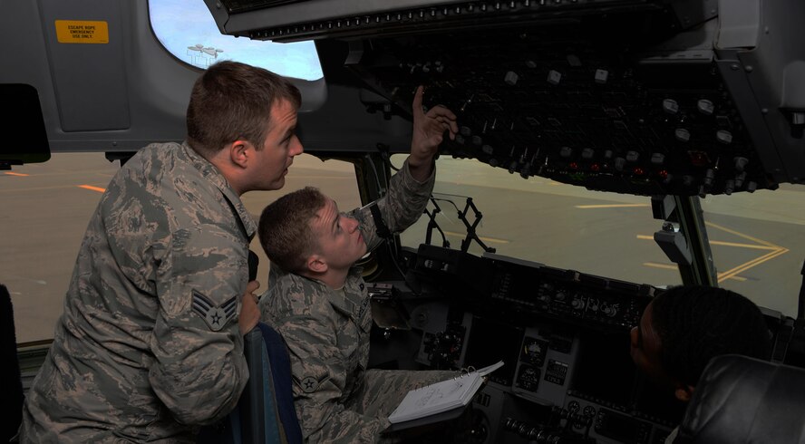 Senior Airman Anthony Boone (Back Left), 860th Aircraft Maintenance Squadron C-17 Globemaster III crew chief, explains the refueling process to Airman Rudy Katz (Front Left), 860th AMXS communications and navigations systems specialist, while Senior Airman Khalil Hart (Right), 860th AMXS C-17 crew chief looks on at Travis Air Force Base, Calif., June 15, 2016. Crew chiefs oversee the refueling process during pre-flight inspections to ensure the aircraft maintains proper balance. The Airmen of the 860th AMXS maintain more than a dozen C-17's valued at $2.9 billion. (U.S. Air Force photo by Tech. Sgt. James Hodgman)