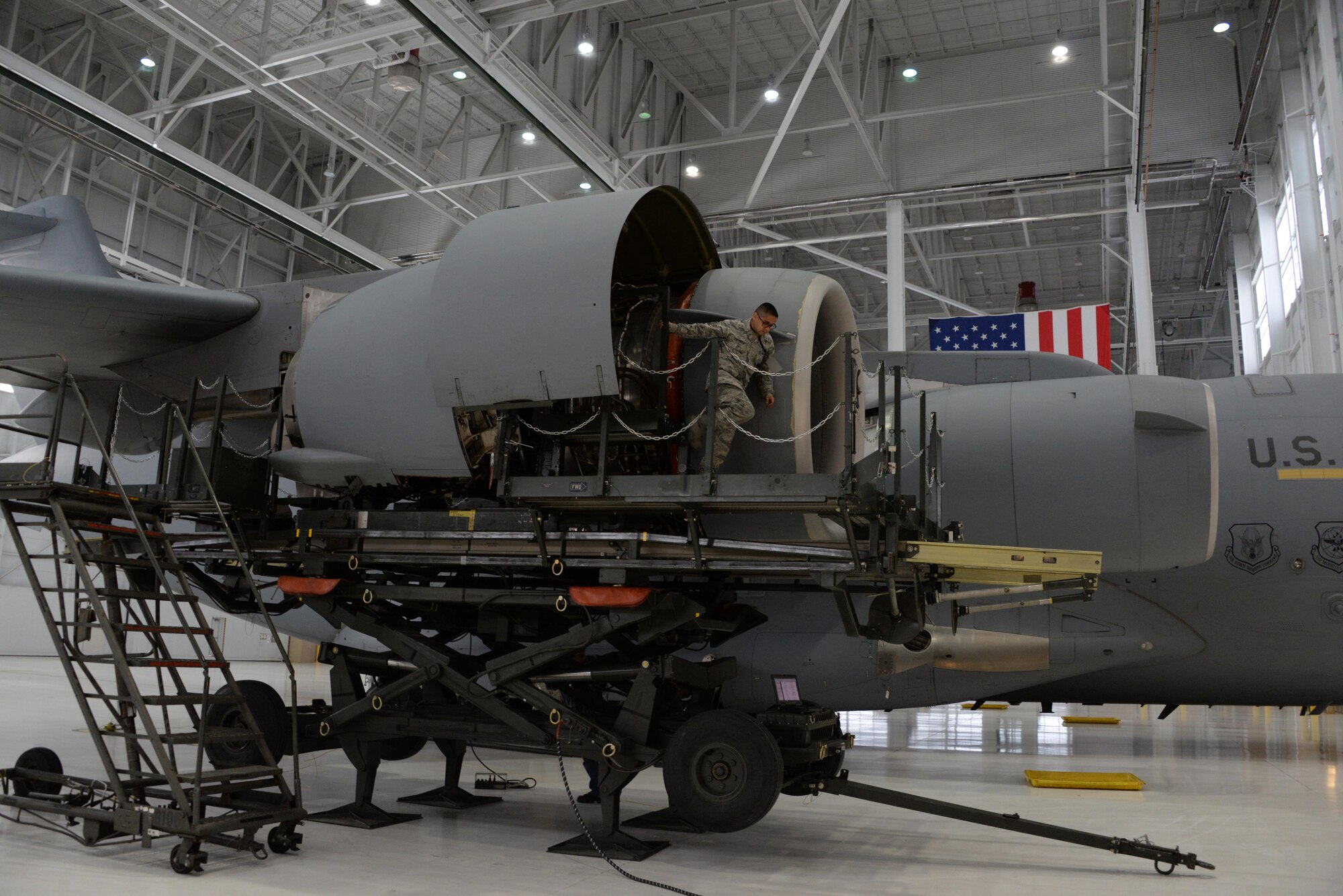 An Airman assigned to the 860th Aircraft Maintenance Squadron, works on a C-17 Globemaster III engine inside a hangar at Travis Air Force Base, Calif., June 15, 2016. The 860th AMXS is responsible for maintaining more than a dozen C-17's valued at $2.9 billion. Photo altered for security reasons. (U.S. Air Force photo by Tech. Sgt. James Hodgman)