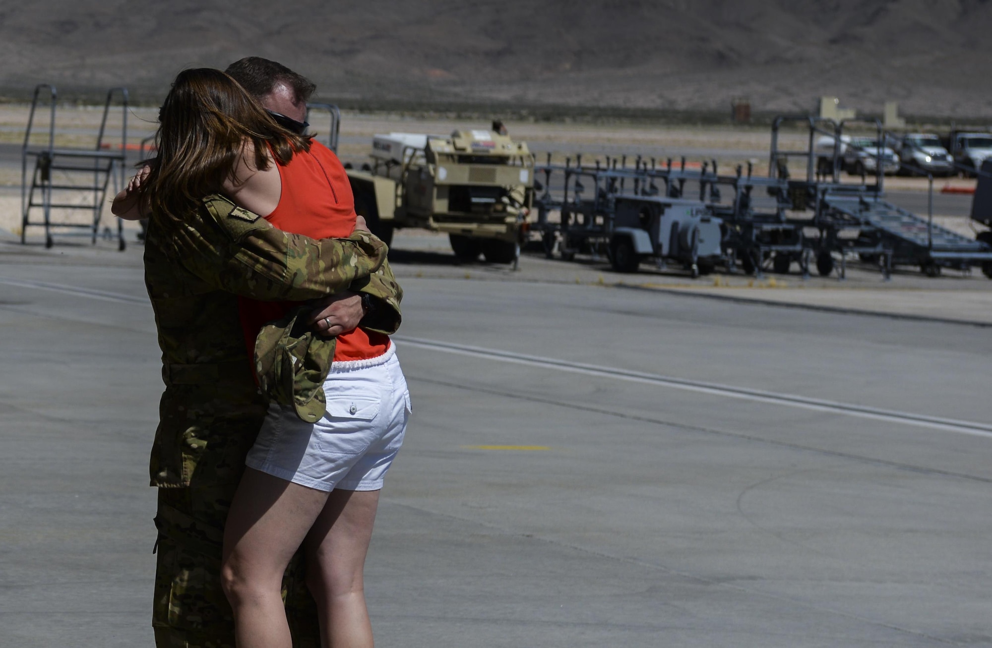 Staff Sgt. Adam Koniar, 66th Rescue Squadron Special Mission Aviator Instructor, embraces his wife after returning home from deployment at Nellis Air Force Base, Nev., June 7. The primary mission of the deployment was personnel recovery support through all of Afghanistan. (U.S. Air Force photo by Airman 1st Class Kevin Tanenbaum)
