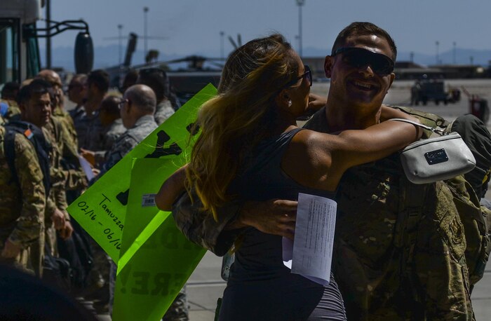 Senior Airman Gregory Tamuzza, 823rd Maintenance Squadron rescue specialist, embraces a loved one after returning home from deployment at Nellis Air Force Base, Nev., June 7. The 823rd MXS and 66th Rescue Squadron returned home to Nellis AFB from a four month deployment
in Afghanistan where they provided recovery support. (U.S. Air Force photo by Airman 1st Class Kevin Tanenbaum)