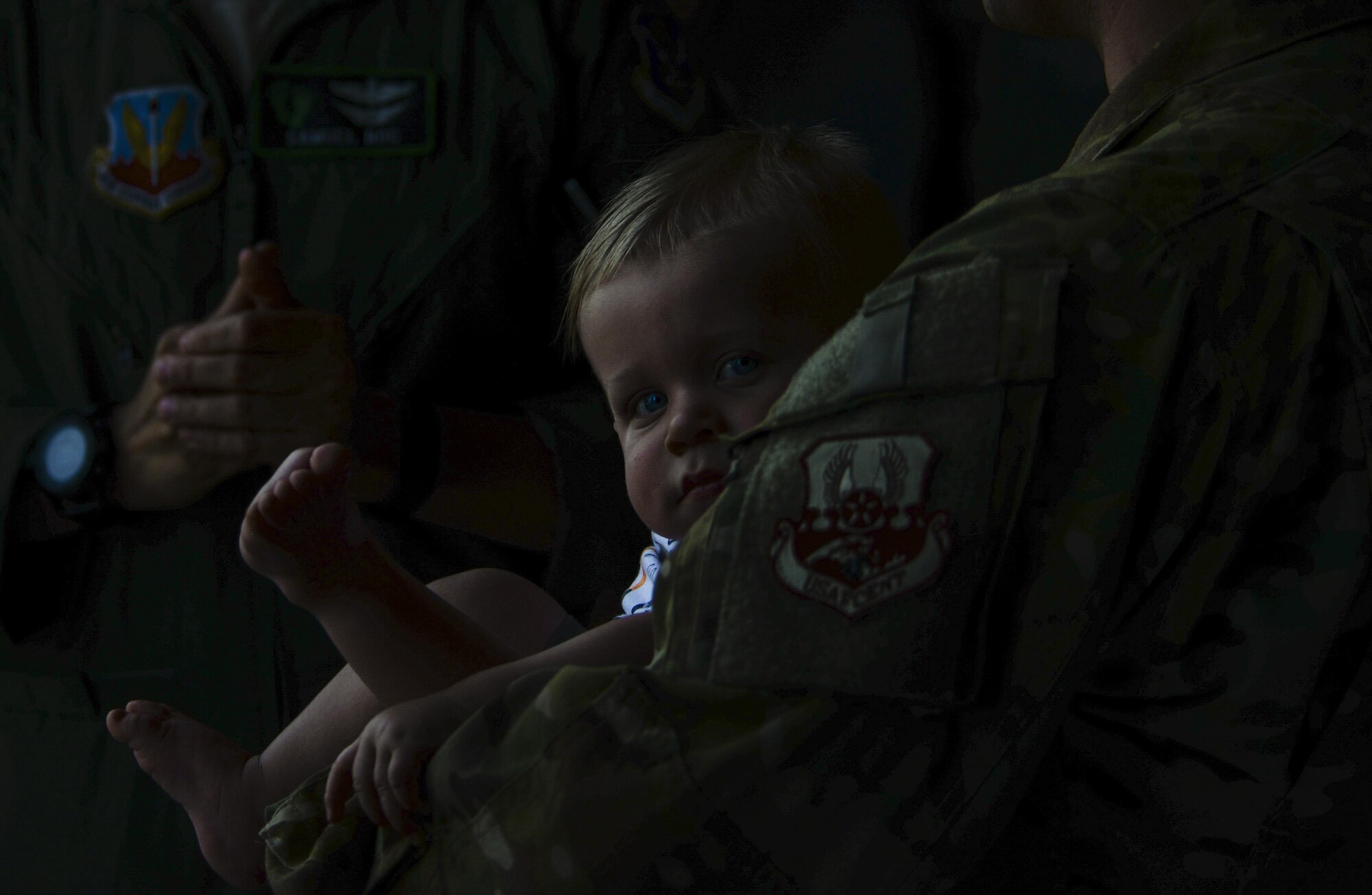 A child rests in the arms of an Airmen who just returned from a deployment to Afghanistan at Nellis Air Force Base, Nev., June 7. Approximately 80 Airmen from the 66th Rescue Squadron and 823rd Maintenance Squadron were welcomed
home June 3 and 7 after being deployed for approximately four months. (U.S. Air Force photo by Airman 1st Class Kevin Tanenbaum)
