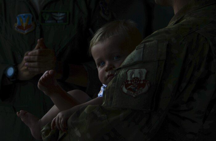 A child rests in the arms of an Airmen who just returned from a deployment to Afghanistan at Nellis Air Force Base, Nev., June 7. Approximately 80 Airmen from the 66th Rescue Squadron and 823rd Maintenance Squadron were welcomed
home June 3 and 7 after being deployed for approximately four months. (U.S. Air Force photo by Airman 1st Class Kevin Tanenbaum)