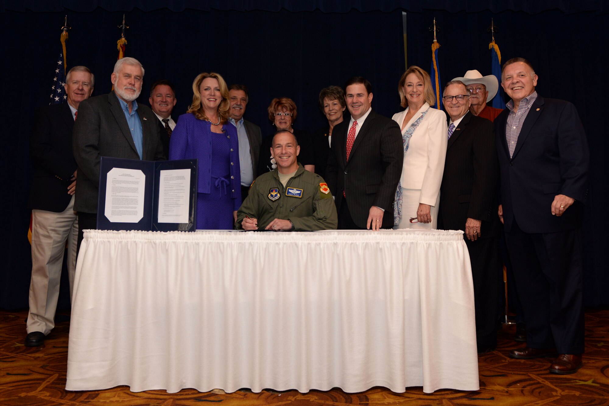 Brig. Gen. Scott Pleus, 56th Fighter Wing commander, signs the memorandum of understanding identifying the structure of the Luke Community Partnership program during the Luke West Valley Council meeting June 16 at Luke AFB, Arizona. The Luke Community Partnership program is part of the Air Force’s Public-Public, Public-Private initiative, known as P4, started in 2012. This partnership provides an ongoing framework and offers a means to effectively combine and use capabilities to enhance mission effectiveness and reduce costs. (U.S. Air Force photo by Staff Sgt. Staci Miller)