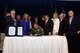 Brig. Gen. Scott Pleus, 56th Fighter Wing commander, signs the memorandum of understanding identifying the structure of the Luke Community Partnership program during the Luke West Valley Council meeting June 16 at Luke AFB, Arizona. The Luke Community Partnership program is part of the Air Force’s Public-Public, Public-Private initiative, known as P4, started in 2012. This partnership provides an ongoing framework and offers a means to effectively combine and use capabilities to enhance mission effectiveness and reduce costs. (U.S. Air Force photo by Staff Sgt. Staci Miller)