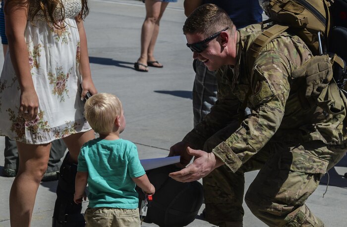 A Senior Airman goes to embrace a child during a gathering after returning home from deployment at Nellis Air Force Base, Nev., June 7. The 823 MXG and 66th RQS were responsible for helping out in certain situations where Special Forces or other soldiers were in need of
assistance and needed to be medical evacuated out. (U.S. Air Force photo by Airman 1st Class Kevin Tanenbaum)