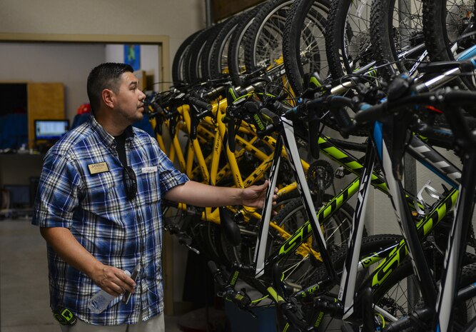 Michael Romijn, Outdoor Recreation director, pulls a mountain bike from the rack at Nellis Air Force Base, Nev., June 6. Outdoor Recreation offers equipment rental to DOD ID cardholders which includes everything from pontoon boats, ski boats, campers, trailers, mountain bikes and kayaks just to name a few. (U.S. Air Force photo by Airman 1st Class Nathan Byrnes) 