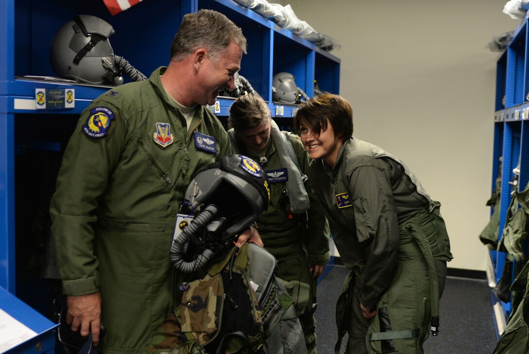 Col. Mark Slocum (left), 4th Fighter Wing commander, and Julie Daniels (right), Military Affairs Committee chairperson, don flight gear, June 14, 2016, at Seymour Johnson Air Force Base, North Carolina. Daniels addresses the needs and concerns of the base to help enhance the communication and relations between the base and Goldsboro community. (U.S. Air Force photo by Airman 1st Class Ashley Williamson/Released)