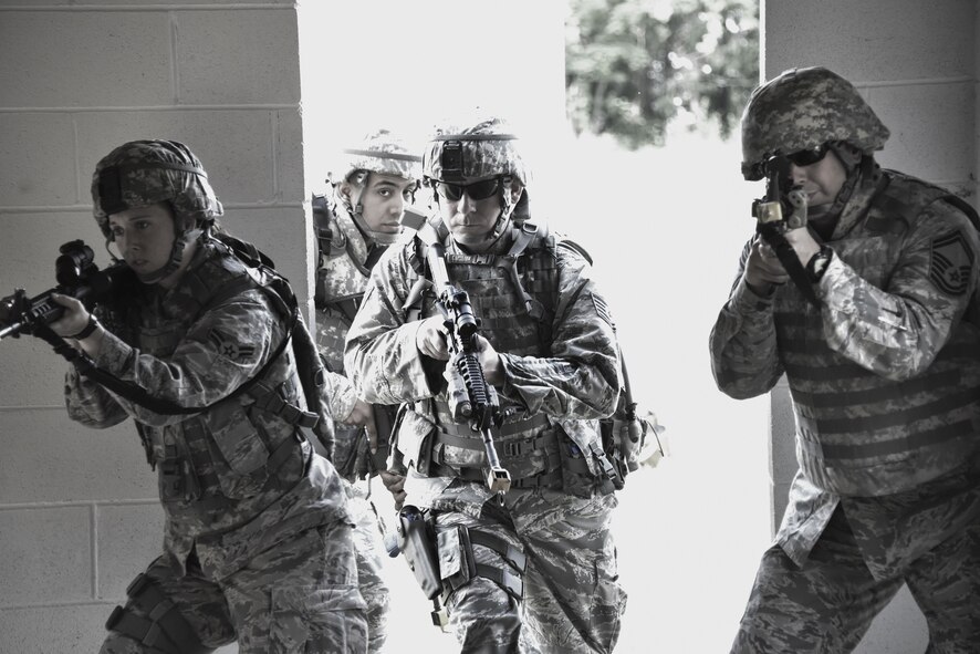 A 911th Security Forces Squadron fire team makes entry into a building during military operations in urban terrain training at Camp Dawson, West Virginia, June 7, 2016. The MOUT training focuses on teamwork and communication by fire teams to clear and secure buildings in an urban environment. (U.S. Air Force photo by Staff. Sgt. Jonathan Hehnly)