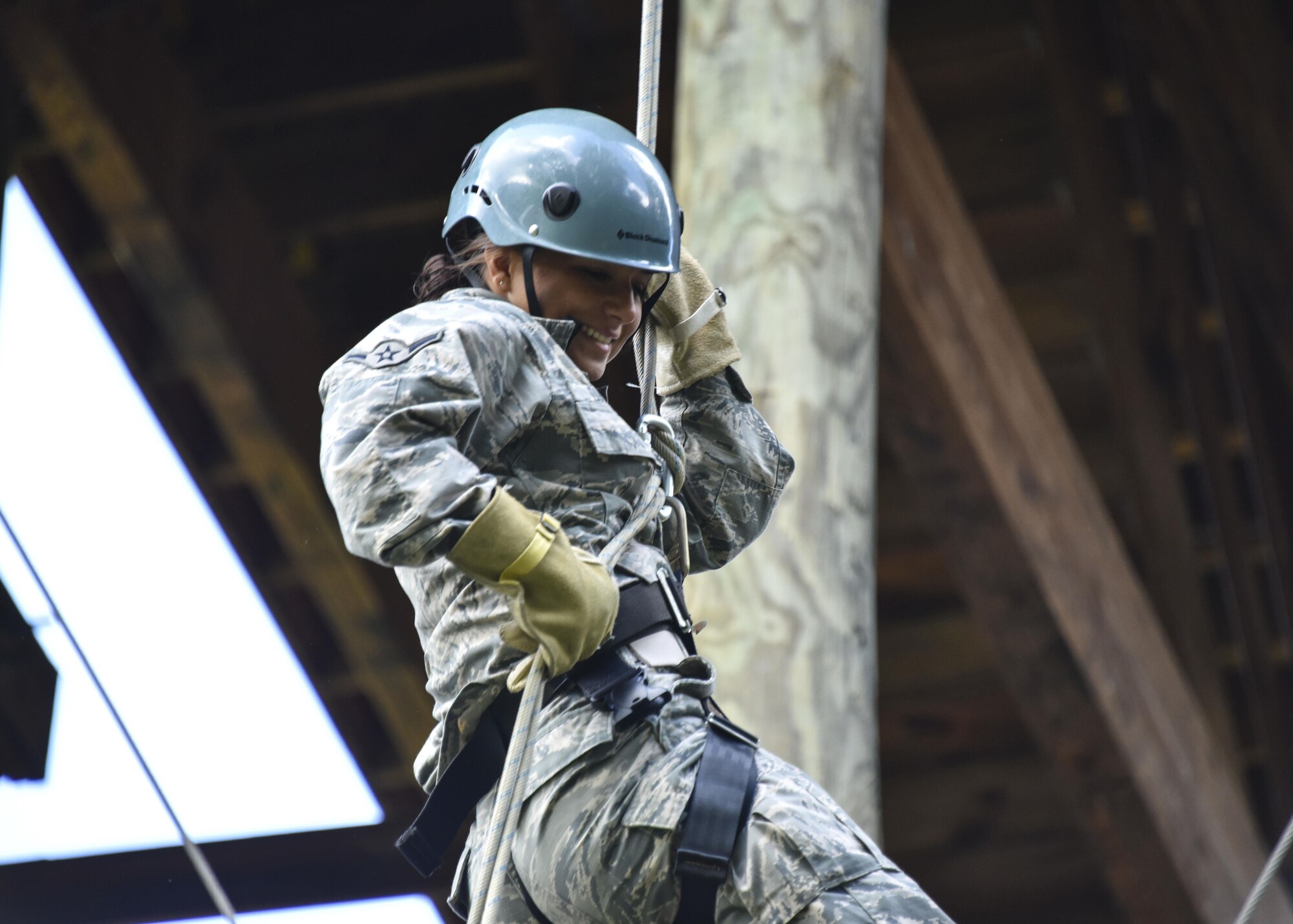 Airman Nicole Dallo, a 911th Security Forces Squadron fire team member rappels from a five-story tower at Camp Dawson, West Virginia, June 8, 2016. Army combat engineers from the 119th Engineer Company (Sapper), West Virginia Army National Guard out of Moundsville, West Virginia, provided rappelling training and oversight during the 911th SFS’s annual tour at the West Virginia Army National Guard installation. (U.S. Air Force photo by Staff. Sgt. Jonathan Hehnly)