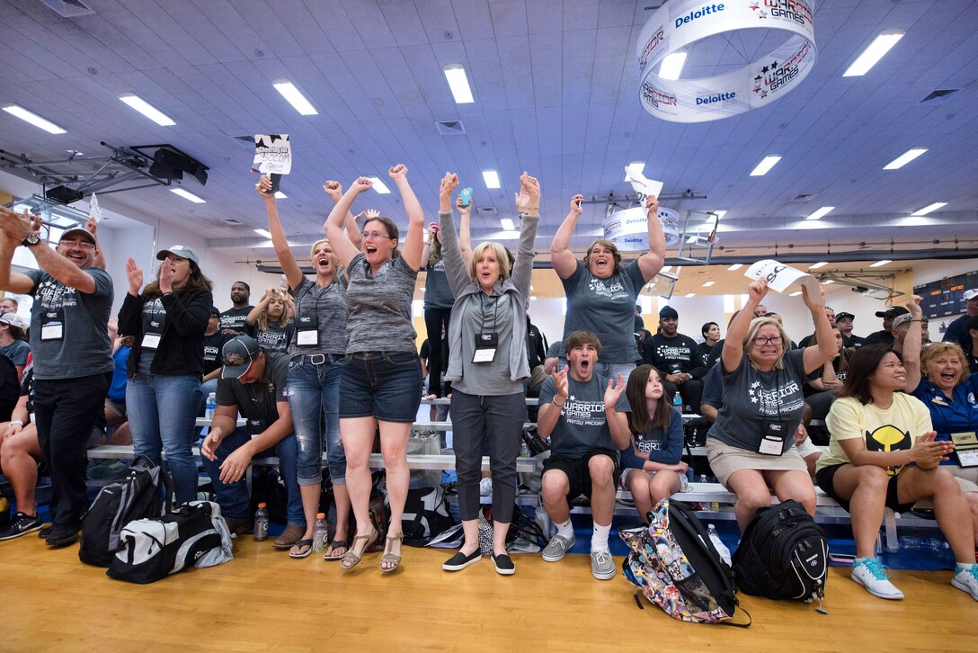 Family members and troops cheer for the U.S. Special Operations Command team after its victory against Team Army in sitting volleyball during the 2016 Department of Defense Warrior Games at the U.S. Military Academy in West Point, N.Y., June 15, 2016. DoD photo by Roger Wollenberg