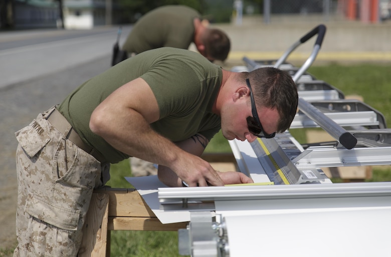 Lance Cpl. Benjamin M. Pintar, a combat engineer with Company C, 6th Engineer Support Battalion, 4th Marine Logistics Group, Marine Forces Reserve, takes measurements while building aluminum fascia trim for a barracks renovation project during exercise Red Dagger at Fort Indiantown Gap, Penn., June 11, 2016. As part of the exercise, the Marines and British commandos worked on various renovation and construction projects around the Army base.  Exercise Red Dagger is a bilateral training exercise that gives Marines an opportunity to exchange tactics, techniques and procedures as well as build working relationships with their British counterparts. (U.S. Marine Corps photo by Sgt. Ian Leones/Released)