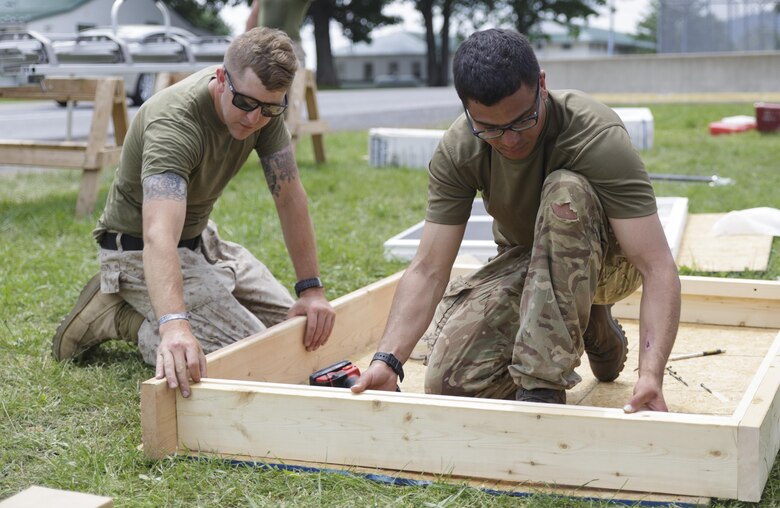 Petty Officer 3rd Class Benjamin Rawson (left), a Fleet Marine Force hospital corpsman with Company C, 6th Engineer Support Battalion, 4th Marine Logistics Group, Marine Forces Reserve, and Lance Cpl.  Edward Joseph (right), a team leader with 131 Commando Squadron Royal Engineers, British army, build a window frame for a barracks renovation project at Fort Indiantown Gap, Penn., June 11, 2016. As part of the exercise, the Marines and British commandos worked on various renovation and construction projects around the Army base. Exercise Red Dagger is a bilateral training exercise that gives Marines an opportunity to exchange tactics, techniques and procedures as well as build working relationships with their British counterparts. (U.S. Marine Corps photo by Sgt. Ian Leones/Released)