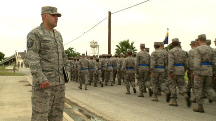 Master Sgt. Raul Hernandez Jr., 326th Training Squadron acting superintendent, observes Air Force basic trainees as they march to the Pfingston Reception Center at Joint Base San Antonio-Lackland. Air Education and Training Command recognized him as the 2015 military training instructor of the year. 
