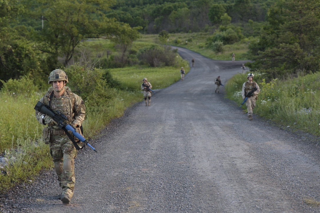 An integrated platoon of Marines with Company C, 6th Engineer Support Battalion, 4th Marine Logistics Group, Marine Forces Reserve, and commandos with 131 Commando Squadron Royal Engineers, British army, patrol a road during exercise Red Dagger at Fort Indiantown Gap, Penn., June 13, 2016. Exercise Red Dagger is a bilateral training exercise that gives Marines an opportunity to exchange tactics, techniques and procedures as well as build working relationships with their British counterparts. (U.S. Marine Corps photo by Sgt. Ian Leones/Released)