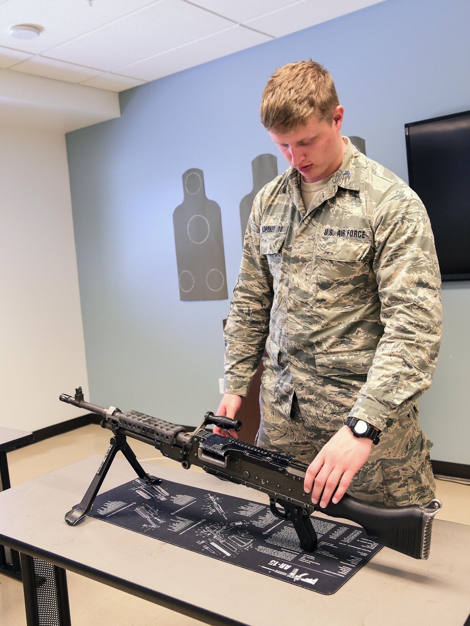 Cadet Alex Korskey, U.S. Air Force Academy, examines a M249 Light Machine Gun during a weapons briefing hosted by the 460th Security Forces Squadron Combat Arms flight June 15, 2016, at Buckley Air Force Base, Colo. The cadets toured Buckley’s units and missions, while engaging with leaders of all ranks in order to gain a better understanding of an operational air force base. (U.S. Air Force photo by Tech. Sgt. Nicholas Rau)