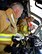Senior Airman Mary Warford, 932nd Airlift Wing Civil Engineering Squadron firefighter, goes over procedures to use the fire suppression system on special firetruck used to extinguish aircraft fires with Col. Jonathan Philebaum, 932nd AW commander, May 14, 2016, at the Scott Air Force Base fire training grounds.  (U.S. Air Force photo by Tech. Sgt. Christopher Parr)