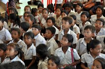 Children from the Angchhum Trapeang Chhouk School in Kampot Province, Cambodia listen intently as they learn about oral hygiene as part of a health services outreach event June 15, 2016, for Pacific Angel 16-2 in Cambodia. The children were taught how and when to properly brush their teeth, then were provided a general dental examination and fluoride treatment. Oral hygiene is particularly important for children because if primary teeth get cavities, it could later cause infection or problems with their adult teeth. The school outreach event was planned and executed by non-governmental agencies in coordination with U.S., Cambodian, Australian, Vietnamese and Thai counterparts in order to educate the population on preventative health throughout the region. (U.S. Air Force photo by Capt. Susan Harrington/Released)