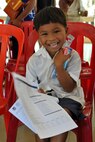 A young Cambodian boy smiles after he receives his toothbrush and toothpaste from Pacific Angel 16-2 Cambodia dentists and dental technicians June 15, 2016.  Dental providers from East Meets West, a non-governmental organization based in Vietnam, partnered with U.S., Cambodian, Australian, Vietnamese and Thai military counterparts as part of Pacific Angel 16-2, a multilateral humanitarian assistance/civil military mission, to provide the multitude of children basic dental examinations and, more importantly, educate them on the importance of proper dental hygiene. Each child was given a toothbrush and toothpaste and was educated on how to properly brush their teeth at home. (U.S. Air Force photo by Capt. Susan Harrington/Released) 