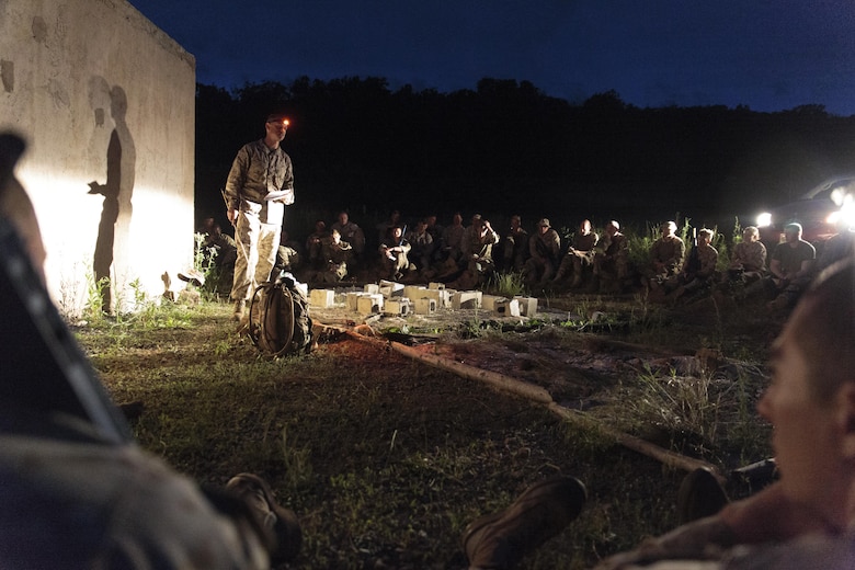 Marines with Company C, 6th Engineer Support Battalion, 4th Marine Logistics Group, Marine Forces Reserve, and commandos with 131 Commando Squadron Royal Engineers, British army, receive a mission briefing before a simulated night time raid on an urban compound during exercise Red Dagger at Fort Indiantown Gap, Penn., June 13, 2016. Exercise Red Dagger is a bilateral training exercise that gives Marines an opportunity to exchange tactics, techniques and procedures as well as build working relationships with their British counterparts. (U.S. Marine Corps photo by Sgt. Ian Leones/Released)