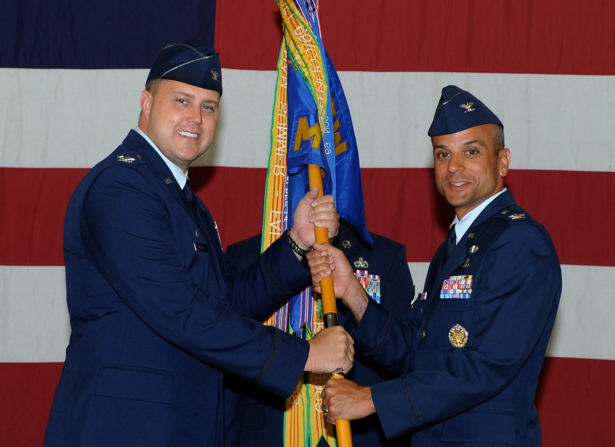 Col. John Nichols, 14th Flying Training Wing Commander, passes the 14th Mission Support Group guidon to Col. Anthony Sansano, the new 14th MSG Commander, during a change of command ceremony June 16 at Columbus Air Force Base, Mississippi. (U.S. Air Force photo/Elizabeth Owens)