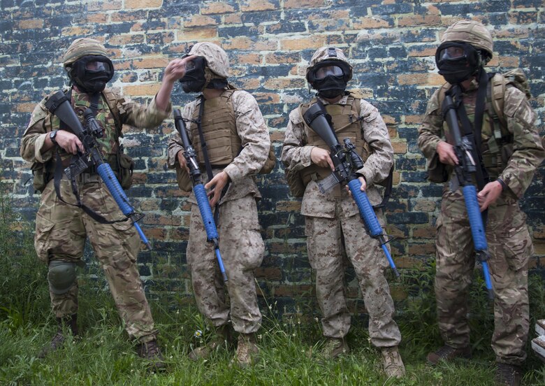 A fire team of Marines with Company C, 6th Engineer Support Battalion, 4th Marine Logistics Group, Marine Forces Reserve, and commandos with 131 Commando Squadron Royal Engineers, British army, plans their next movement during an urban assault simulation during exercise Red Dagger at Fort Indiantown Gap, Penn., June 13, 2016. Red Dagger is a bilateral training exercise that gives Marines an opportunity to exchange tactics, techniques and procedures as well as build working relationships with their British counterparts. (U.S. Marine Corps photo by Sgt. Ian Leones/Released)