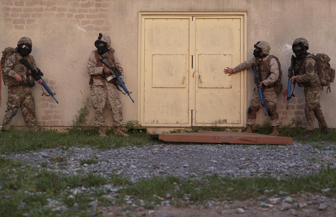 A fire team of Marines with Company C, 6th Engineer Support Battalion, 4th Marine Logistics Group, Marine Forces Reserve, and commandos with 131 Commando Squadron Royal Engineers, British army, prepare to clear a high-threat building during a simulated raid on an urban compound at exercise Red Dagger at Fort Indiantown Gap, Penn., June 13, 2016. Red Dagger is a bilateral training exercise that gives Marines an opportunity to exchange tactics, techniques and procedures as well as build working relationships with their British counterparts. (U.S. Marine Corps photo by Sgt. Ian Leones/Released)