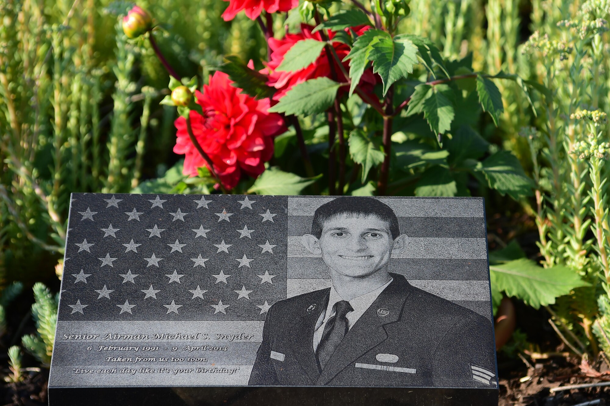 A memorial garden for Senior Airman Michael S. Snyder lays in front of the 460th Space Communications Squadron Building June 16, 2016, on Buckley Air Force Base, Colo. Snyder was tragically killed in 2014 by a drunk driver while riding his motorcycle off base. (U.S. Air Force photo by Airman 1st Class Luke W. Nowakowski/Released)
