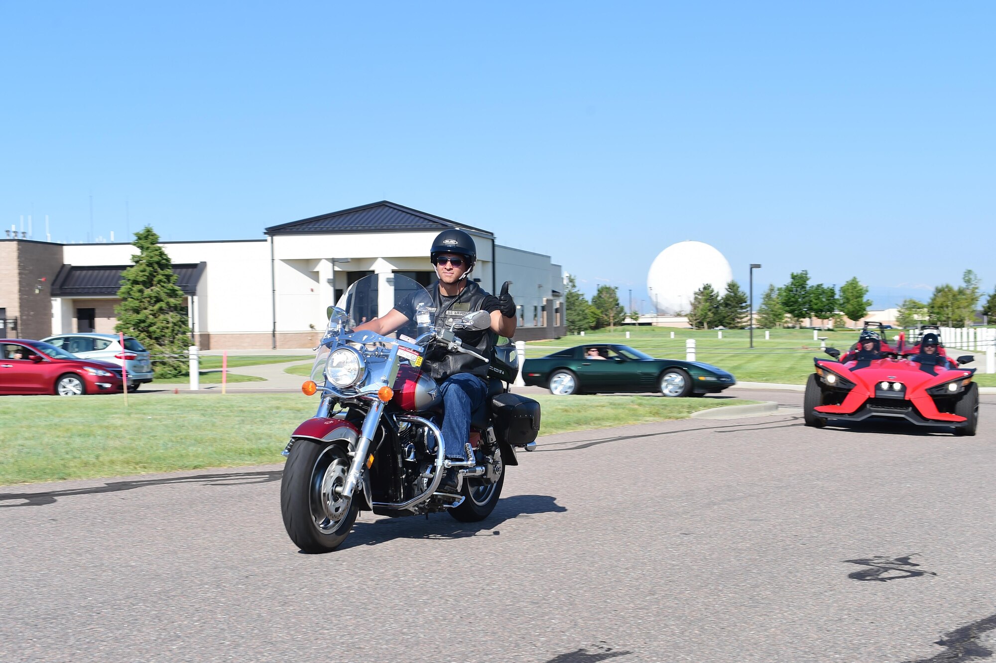 Tech. Sgt. Michael Castillo, 460th Space Communication Squadron quality assurance, rolls by on his motorcycle at the beginning of the Snyder Ride June 16, 2016, on Buckley Air Force Base, Colo. The Snyder Ride is a memorial ride in honor of Senior Airman Michael S. Snyder, who was tragically killed in 2014, by a drunk driver. (U.S. Air Force photo by Airman 1st Class Luke W. Nowakowski/Released)