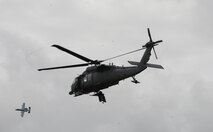 An Alaska National Guard HH-60 Pave Hawk helicopter from the 210th Rescue Squadron out of Eielson Air Force Base, Alaska, takes off after a combat search and rescue demonstration June 13, 2016, in the Joint Pacific Alaska Range Complex as an A-10 Thunderbolt II with the 354th Fighter Squadron from Davis-Monthan Air Force Base, Ariz., passes by during RED FLAG-Alaska (RF-A) 16-2. RF-A is a series of Pacific Air Forces commander-directed field training exercise that enable U.S. and partner nation forces to sharpen their combat skills by flying simulated combat sorties alongside joint and international forces in a realistic threat environment. (U.S. Air Force photo by Staff Sgt. Ashley Nicole Taylor/Released)