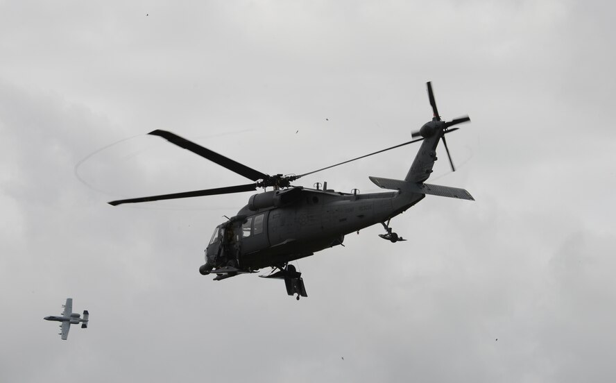 An Alaska National Guard HH-60 Pave Hawk helicopter from the 210th Rescue Squadron out of Eielson Air Force Base, Alaska, takes off after a combat search and rescue demonstration June 13, 2016, in the Joint Pacific Alaska Range Complex as an A-10 Thunderbolt II with the 354th Fighter Squadron from Davis-Monthan Air Force Base, Ariz., passes by during RED FLAG-Alaska (RF-A) 16-2. RF-A is a series of Pacific Air Forces commander-directed field training exercise that enable U.S. and partner nation forces to sharpen their combat skills by flying simulated combat sorties alongside joint and international forces in a realistic threat environment. (U.S. Air Force photo by Staff Sgt. Ashley Nicole Taylor/Released)