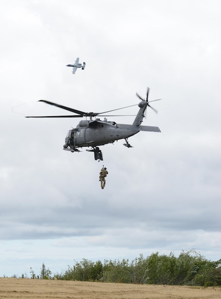 U.S. Air Force pararescuemen with the 210th Rescue Squadron out of Eielson Air Force Base, Alaska, perform a combat search and rescue demonstration June 13, 2016, in the Joint Pacific Alaska Range Complex as an A-10 Thunderbolt II with the 354th Fighter Squadron from Davis-Monthan Air Force Base, Ariz., passes by during RED FLAG-Alaska 16-2. The demonstration was for the Executive Observer Program, which presents U.S. Pacific Air Forces’ premier multinational large force employment exercise while building partnerships with senior airpower leaders from the global community. (U.S. Air Force photo by Staff Sgt. Ashley Nicole Taylor/Released)