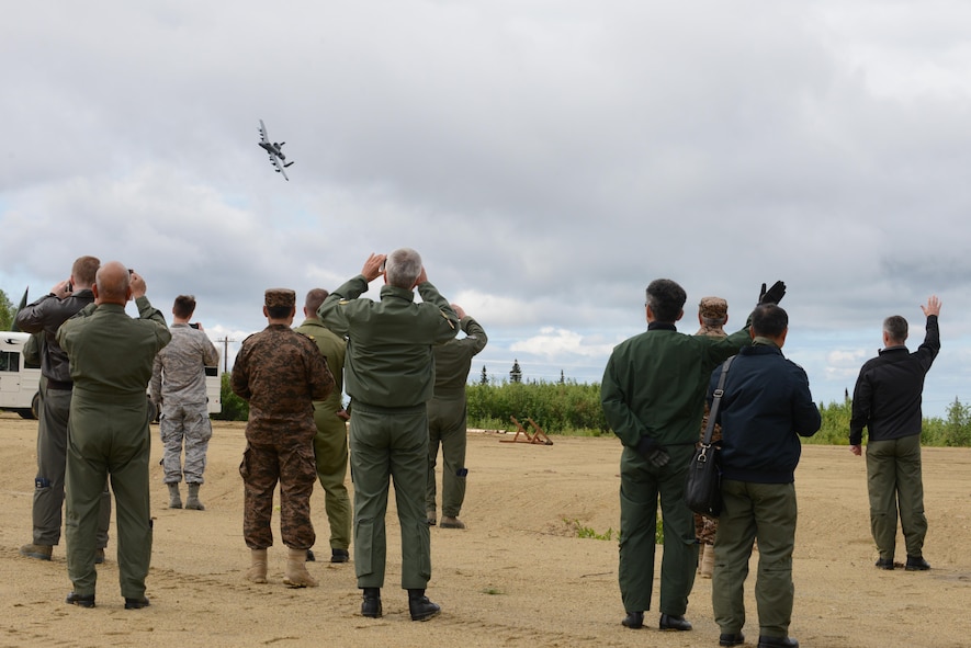 U.S. Air Force and senior airpower leaders from the global community watch as an A-10 Thunderbolt II from Davis-Monthan Air Force Base, Ariz., flies by in a show of force demonstration for the Executive Observer Program (EOP), June 13, 2016, in the Joint Pacific Alaska Range Complex during RED FLAG-Alaska 16-2. The EOP allows participants the opportunity to experience U.S. Pacific Air Forces’ premier multinational large force employment. (U.S. Air Force photo by Staff Sgt. Ashley Nicole Taylor/Released)