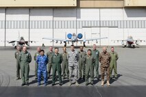 After experiencing show of force demonstrations that highlighted combat capabilities offered to nations participating in RED FLAG-Alaska (RF-A) exercises, senior leaders from the global community stand together for a group photo in front of RF-A 16-2 participating fighter jets June 13, 2016, at Eielson Air Force Base, Alaska. Leaders spent a total of four days together at Joint Base Elmendorf-Richardson and Eielson strengthening foreign relations and showcasing the joint environment unmatched by other exercises. (U.S. Air Force photo by Staff Sgt. Ashley Nicole Taylor/Released)
