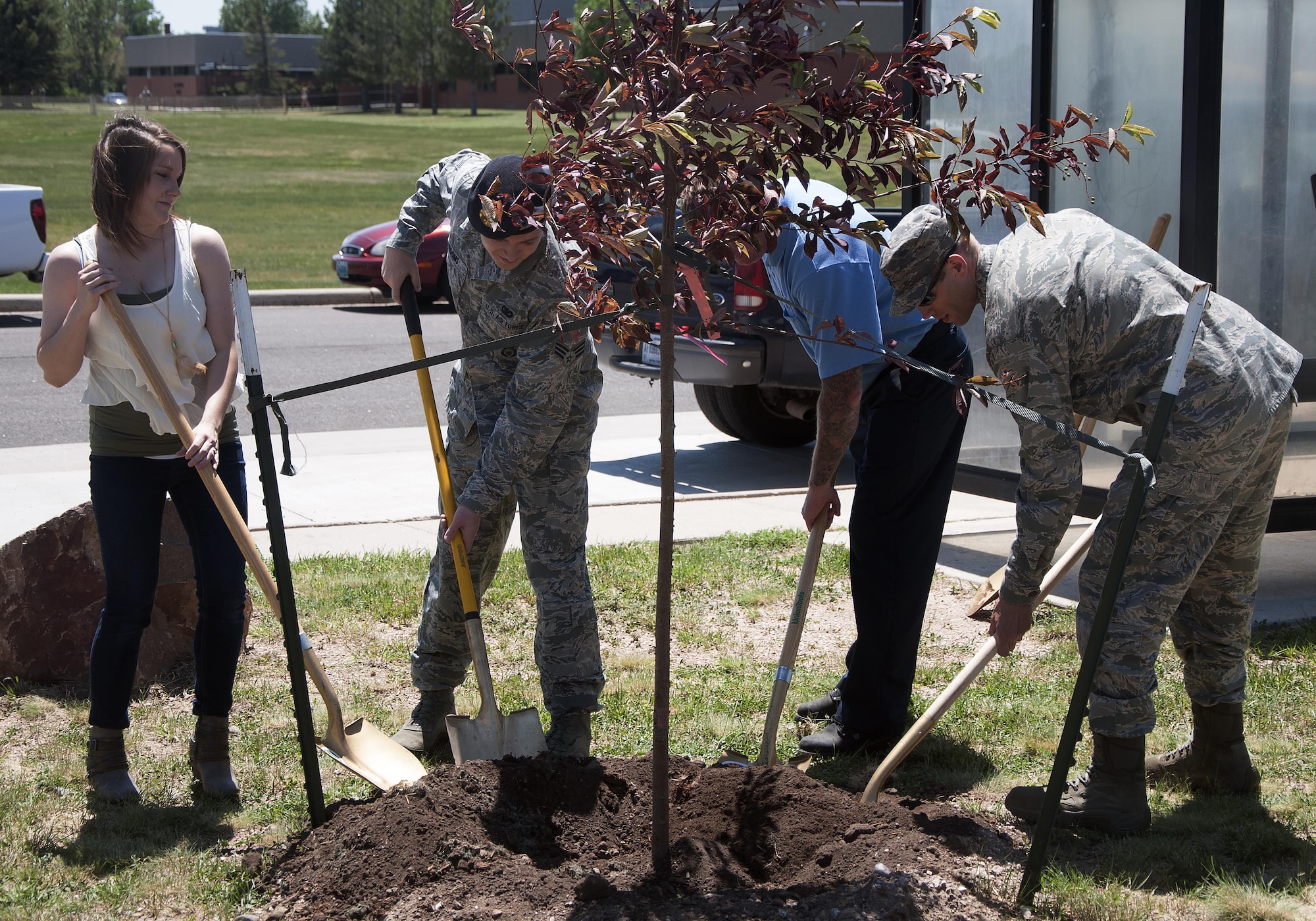 Mighty Ninety Airmen finish planting a tree June 16, 2016, north of the medical treatment facility on F.E. Warren Air Force Base. The wing has coordinated the planting of a tree for the past four years. (U.S. Air Force photo by Senior Airman Brandon Valle)