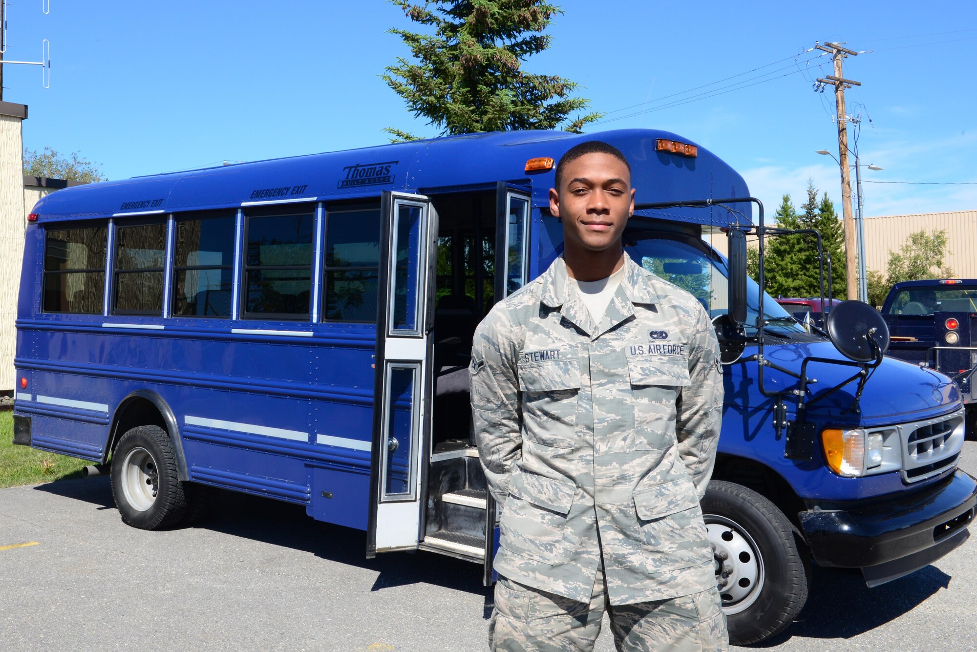 U.S. Air Force Airman Donovan Stewart, a 354th Logistics Readiness Squadron vehicle operator, takes a short break for a photo June 15, 2016, at Eielson Air Force Base, Alaska. Stewart was the driver for the visit of Japanese Air Self-Defense Force (JASDF) Warrant Officer Katsumi Yamazaki, the senior enlisted advisor of the JASDF. It was the first time a senior enlisted advisor was able to travel out to meet with his airmen during a RED FLAG-Alaska exercise. (U.S. Air Force photo by Airman 1st Class Cassandra Whitman/Released)
