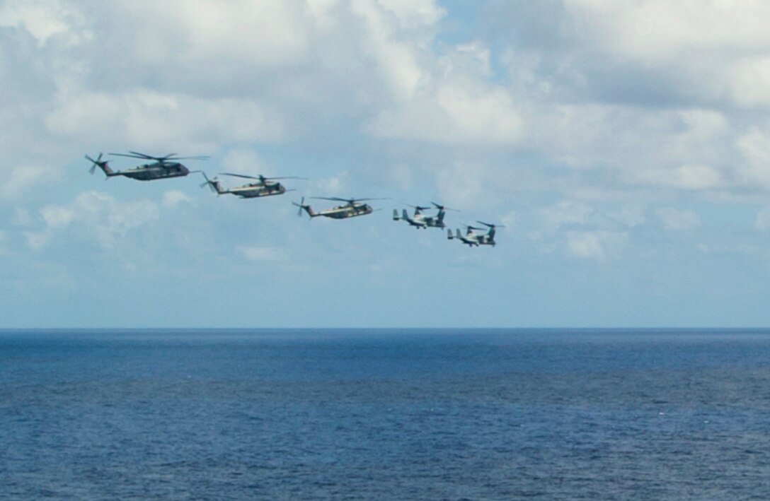 PACIFIC OCEAN (July 29, 2014) - Two MV-22 Ospreys, assigned to Marine Medium Tiltrotor Squadron (VMM) 161, and three CH-53E Super Sea Stallions, assigned to the Marine Heavy Helicopter Squadron (HMH) 465, fly in formation after launching from the amphibious assault ship USS Peleliu (LHA 5) while underway during Rim of the Pacific (RIMPAC) Exercise 2014. Twenty-two nations, 49 ships and six submarines, more than 200 aircraft and 25,000 personnel are participating in RIMPAC exercise from June 26 to Aug. 1, in and around the Hawaiian Islands and Southern California. The world's largest international maritime exercise, RIMPAC provides a unique training opportunity that helps participants foster and sustain the cooperative relationships that are critical to ensuring the safety of sea lanes and security on the world's oceans. RIMPAC 2014 is the 24th exercise in the series that began in 1971.