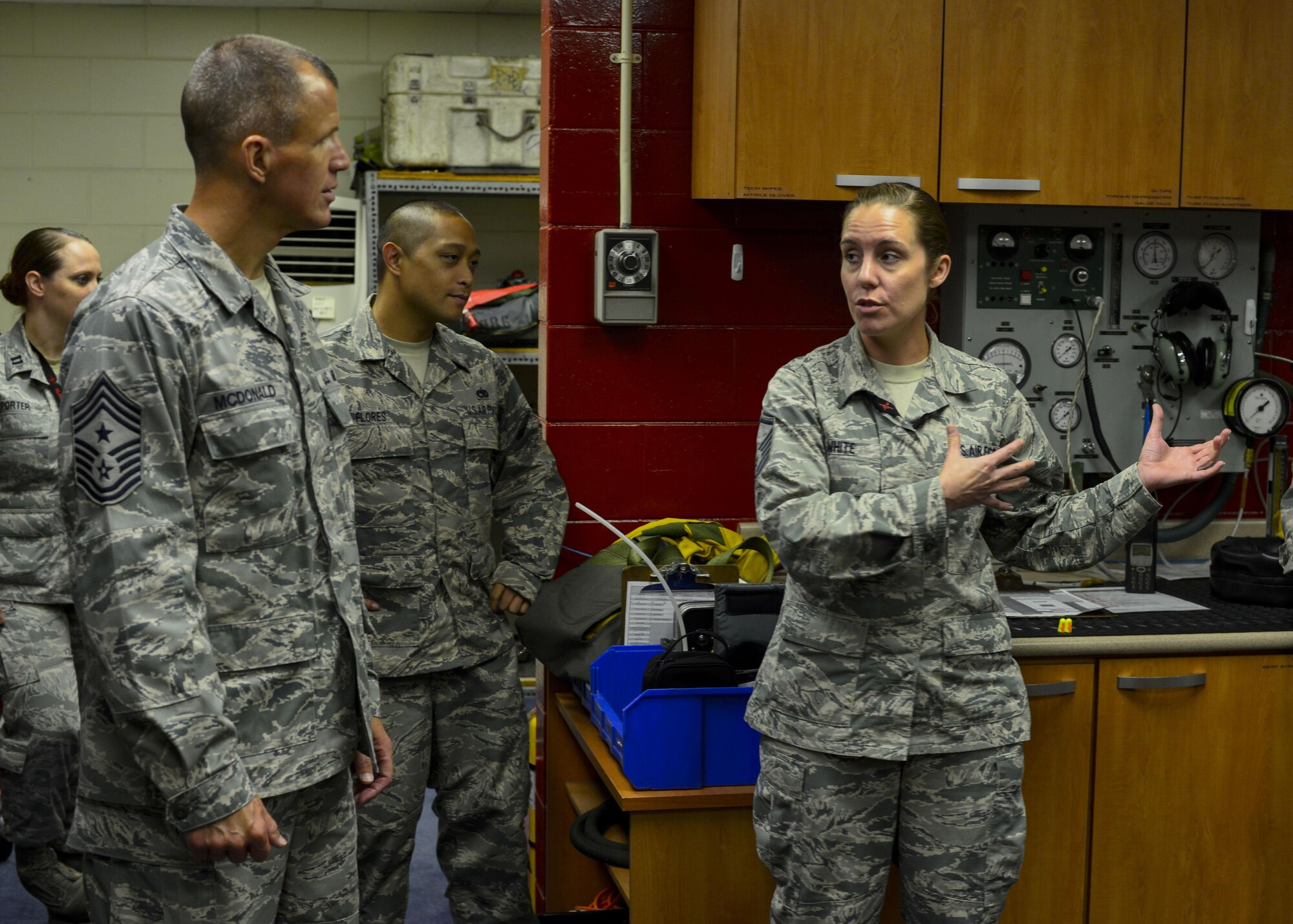 Master Sgt. Amanda White, right, 5th Reconnaissance Squadron aircrew flight equipment supervisor, explains her section’s responsibilities in preparing U-2 Dragon Lady pilots for a flight to Chief Master Sgt. Steve McDonald, Air Combat Command command chief, at Osan Air Base, Republic of Korea, June 16, 2016. The AFE Airmen help U-2 pilots put on their pressurized flight suit, connect them to an oxygen machine and run a pressurization test to ensure there are no malfunctions that could cause an in-flight emergency. (U.S. Air Force photo by Senior Airman Victor J. Caputo/Released)