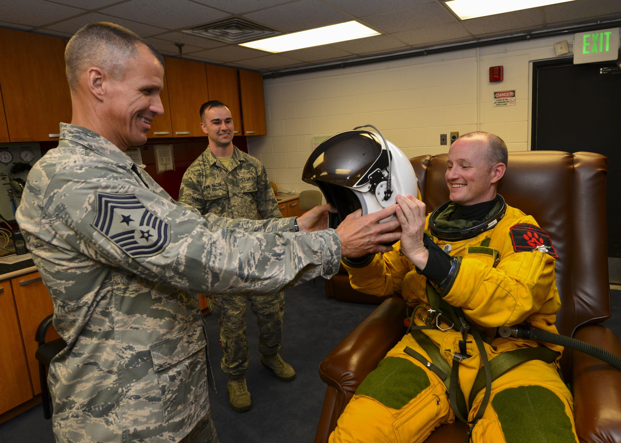Chief Master Sgt. Steve McDonald, Air Combat Command command chief, hands a helmet to Lt. Col. Todd Larsen, 5th Reconnaissance Squadron commander, during preflight preparations at Osan Air Base, Republic of Korea, June 16, 2016. McDonald toured several geographically-separated ACC units at Osan, including the 5th RS, which is part of the 9th Reconnaissance Wing at Beale Air Force Base, Calif. (U.S. Air Force photo by Senior Airman Victor J. Caputo/Released)