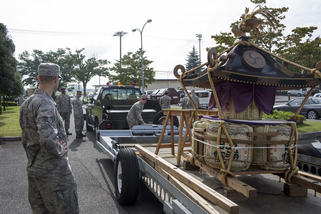 Airmen with the 374th Maintenance Squadron aerospace ground equipment flight load a mikoshi at Yokota Air Base, Japan, Aug. 11, 2015. (U.S. Air Force photo by Yasuo Osakabe/Released) 