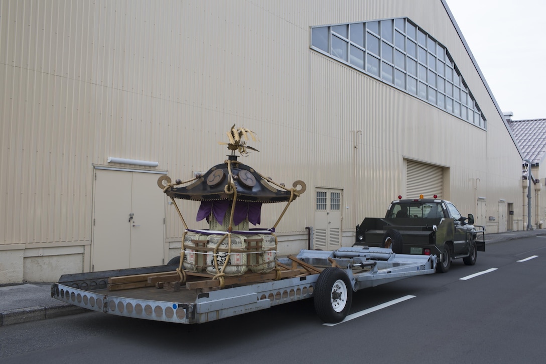 Airmen with the 374th Maintenance Squadron aerospace ground equipment pull a mikoshi at Yokota Air Base, Japan, Aug. 11, 2015. Maintainers refurbished the Wing’s mikoshi in five months. (U.S. Air Force photo by Yasuo Osakabe/Released)   