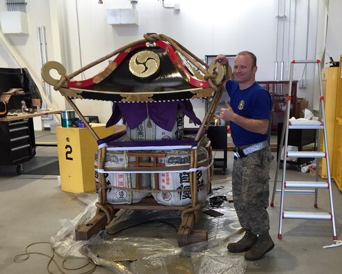 Tech. Sgt. Justin Williams, 374th Maintenance Squadron aerospace ground equipment NCO in charge, poses for a photo after refurbishing the 374th Airlift Wing’s Mikoshi Shrine at Yokota Air Base, Japan, April 15, 2016. Airmen with the 374th MXS and 374th Maintenance Group worked over 150 hours to sand, strip, paint, and treat the wooden surfaces as well as trimming, shaping, and fitting over 10 square meters of brass to replace the ornate work over the course of one month. (Courtesy photo by 374th Maintenance Squadron AGE flight)