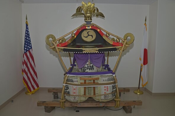 The mikoshi shrine sits on display in the 374th Maintenance Squadron aerospace ground equipment flight during the rededication ceremony at Yokota Air Base, Japan, June 15, 2016. The flight worked more than 150 hours sanding, stripping, painting and treating the wooden surfaces as well as trimming, shaping and fitting over 10 square meters of brass to replace the ornate work over the course of one month. (U.S. Air Force photo by Senior Airman David Owsianka/Released) 