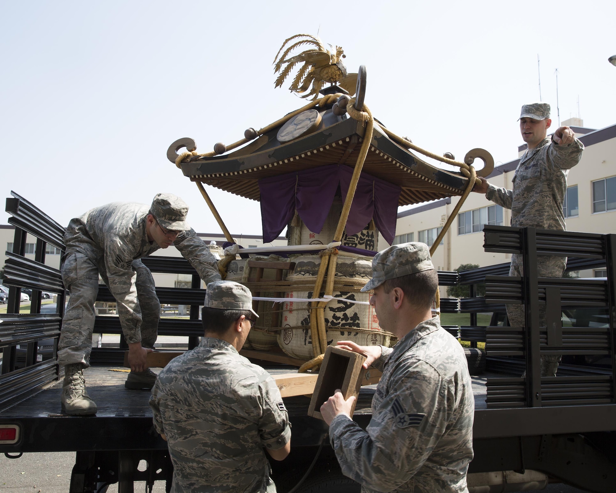 Airmen with the 374th Airlift Wing public affairs download a mikoshi at Yokota Air Base, Japan, May 8, 2013. The Fussa-Yokota Goodwill Exchange Club donated the mikoshi to Yokota Air Base. (U.S. Air Force photo by Yasuo Osakabe/Released)