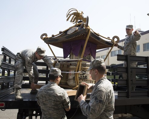 Airmen with the 374th Airlift Wing public affairs download a mikoshi at Yokota Air Base, Japan, May 8, 2013. The Fussa-Yokota Goodwill Exchange Club donated the mikoshi to Yokota Air Base. (U.S. Air Force photo by Yasuo Osakabe/Released)