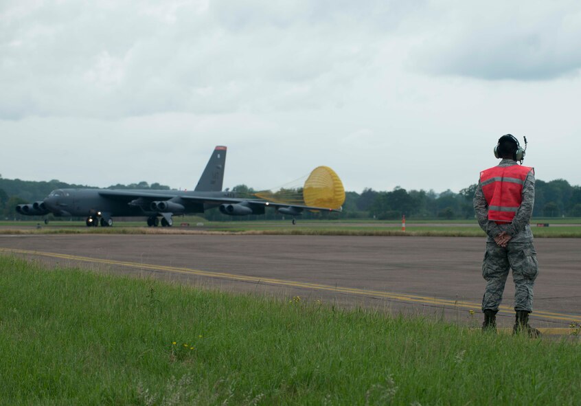 Airman 1st Class Aaron Sampayan, 5th Expeditionary Aircraft Maintenance Squadron assistant dedicated crew chief, stands by to guide a B-52H Stratofortress at RAF Fairford, United Kingdom, June 13, 2016. This was the first flying mission from the bombers in support of exercise Saber Strike 16 which featured the integration of close-air support with allied and partner nation ground forces as well as testing of air deployment of forces and equipment. (U.S. Air Force photo/Senior Airman Sahara L. Fales)