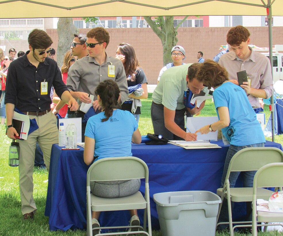 Sandia National Laboratories interns join a welcome party June 9 at Hardin Field. Sandia has more than 1,000 interns and many are from out of state. The interns are college and
high school students. The students assist with research over the course of their internship at SNL. (Photo by Argen Duncan)