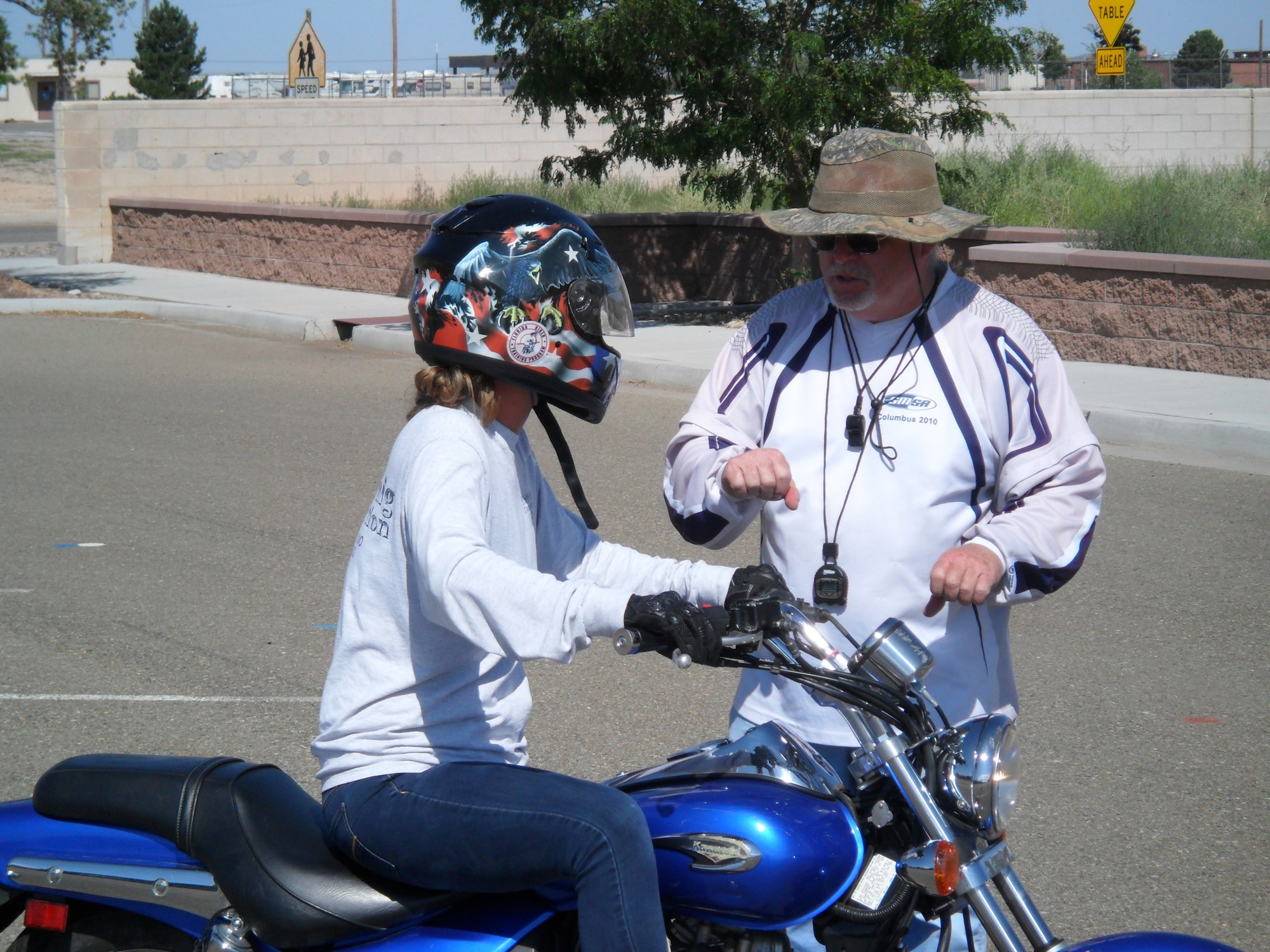 Arthur Albert, motorcycle safety program coordinator and MSF instructor, instructs a student in proper riding technique in a recent MSF Basic Rider Course at Kirtland. (Photo by Steven Dobbs)
