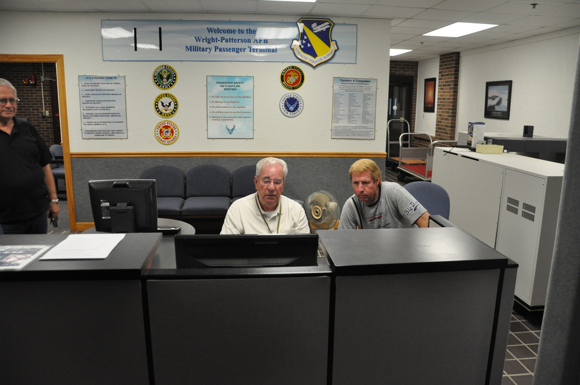 Bobbie Murphy (left), a passenger terminal clerk, schedules customer Marvin Cunningham for a Space-A flight. (U.S. Air Force photo/W. Eugene Barnett Jr.)